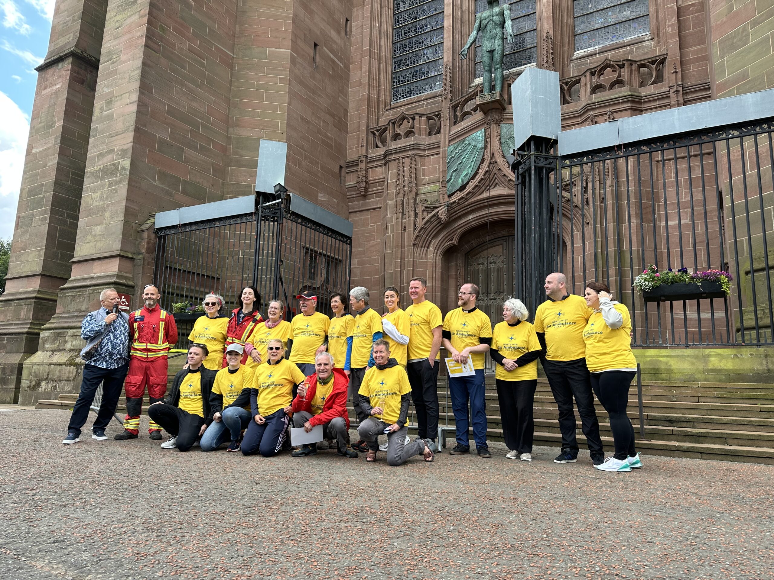 Group of abseilers from 2023 stood in front of the cathedral.