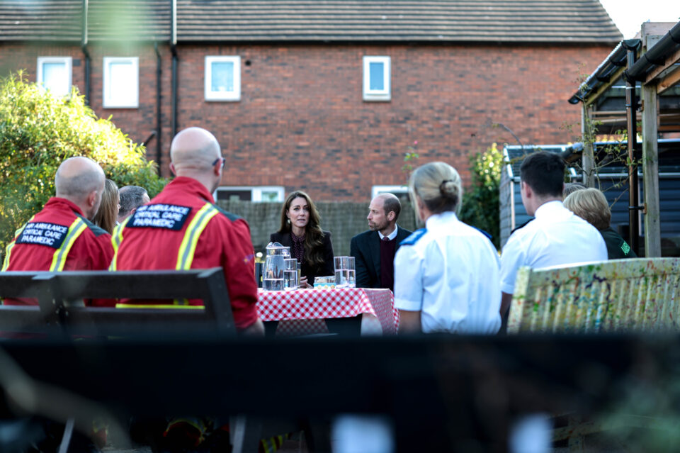 people sat around a table with Their Royal Highnesses, The Prince and Princess of Wales