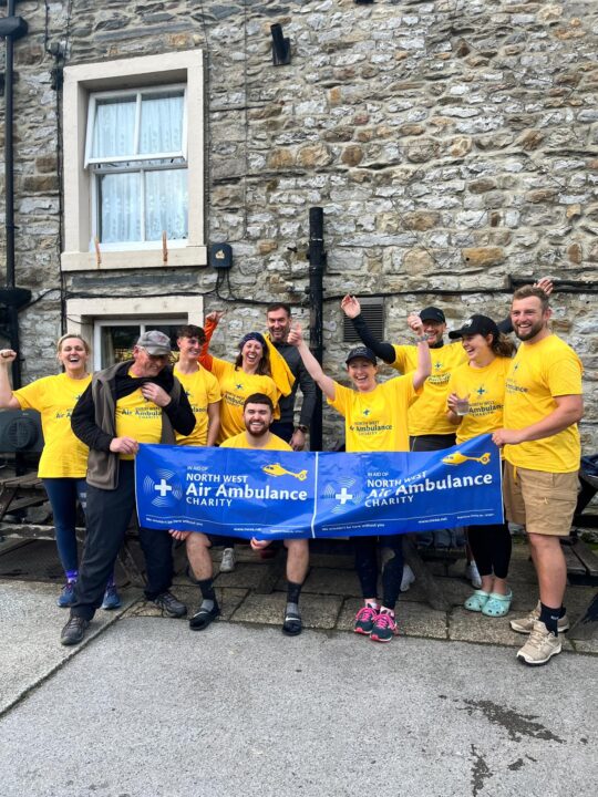 Group of fundraisers dressed in yellow nwaa tee shirts