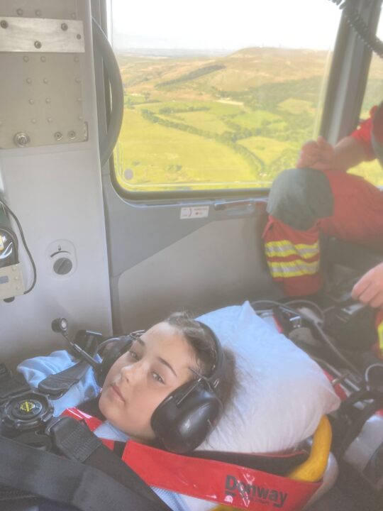 Hannah lay on a stretcher in the back of the helicopter