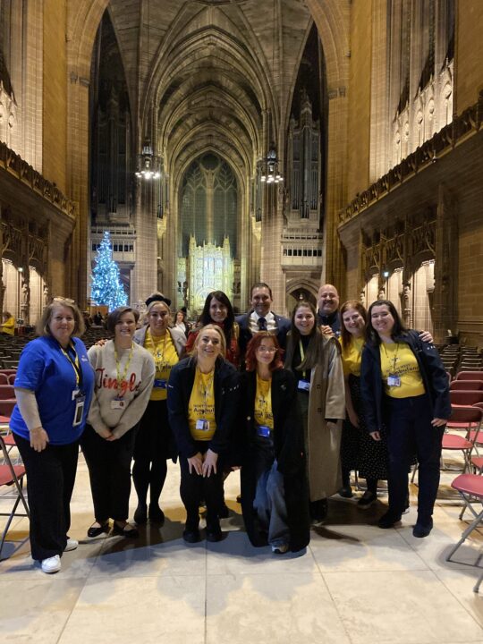 Paul, Gemma and the NWAA team stood posing for a photo inside Liverpool Cathedral 